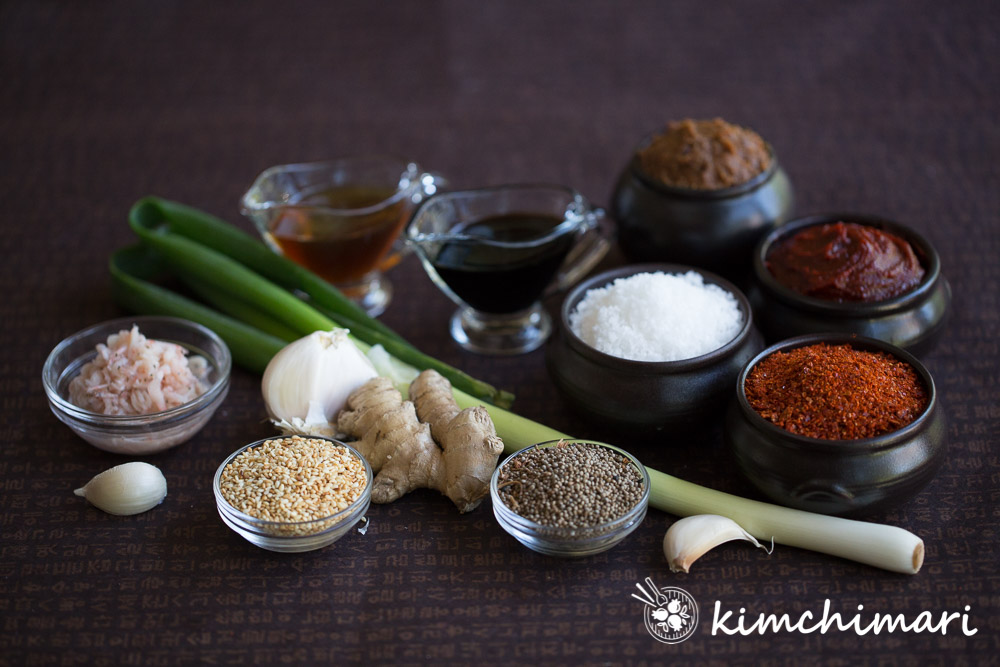 an array of korean cooking ingredients in bowls or just spread out on dark background